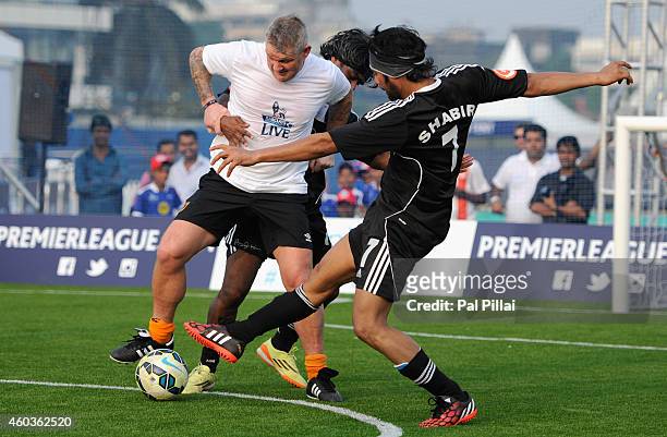 Dean Windass, Hull city legend tackles Bollywood actor Shabir Ahluwalia during an exhibition match played between BPL legends and All star FC from...
