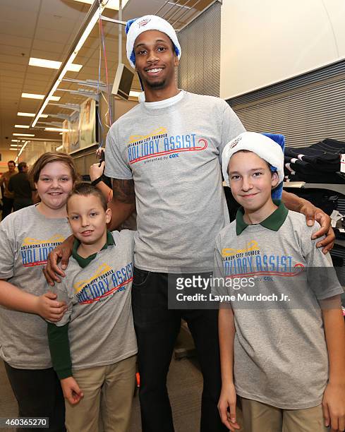 Lance Thomas of the Oklahoma City Thunder shops for the holidays with families from the Sunbeam Family Services Grandparents Raising Grandchildren...