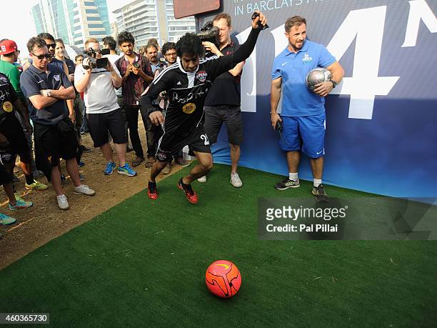 Robbie Fowler, Liverpool legend looks on as Karan Mehra, Bollywood Actor plays a game of football at one of the promotional tents during the Barclays...