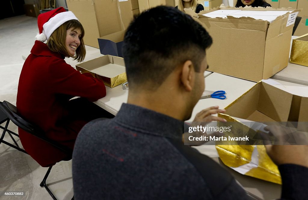 Volunteers At Gift Wrapping Station At Shopping Mall During The Holidays