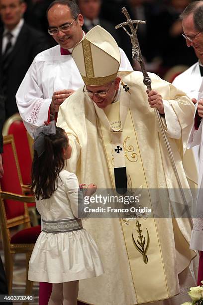 Pope Francis greets a child as he leaves St. Peter's Basilica at the end of a Eucharist celebration on the feast of Our Lady of Guadalupe on December...