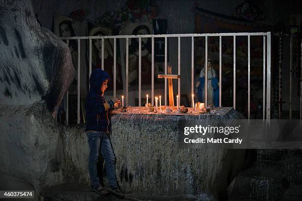 Iraqi Christian boy lights candles inside a shrine in the grounds of Mazar Mar Eillia Catholic Church, that has now become home to hundreds of Iraqi...