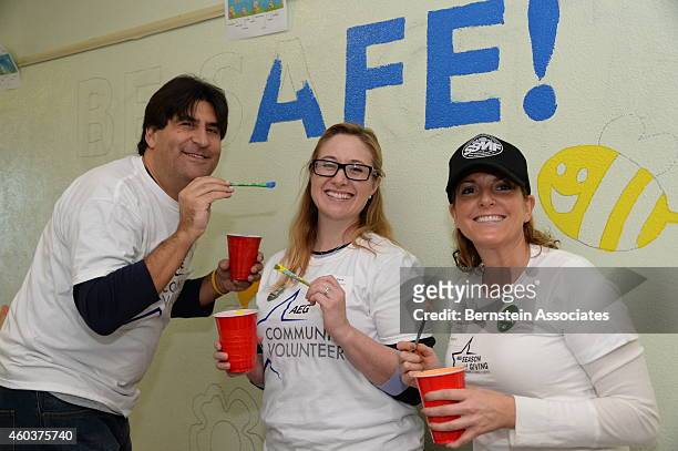 Employees including Michael Roth, Vice President of Communications at AEG, pose for a photo during an AEG Season Of Giving Event at South Park...