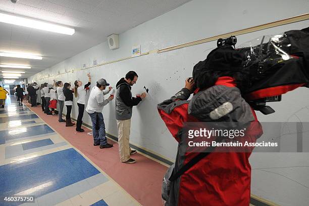 Employees, Including President and CEO Dan Beckerman, paint a hallway during an AEG Season Of Giving Event at South Park Elementary School on...