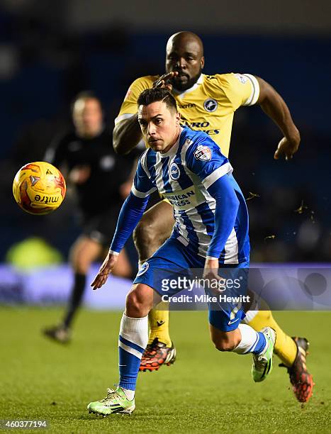 Adrian Colunga of Brighton is chased by Danny Shittu of Millwall during the Sky Bet Championship match between Brighton & Hove Albion and Millwall at...