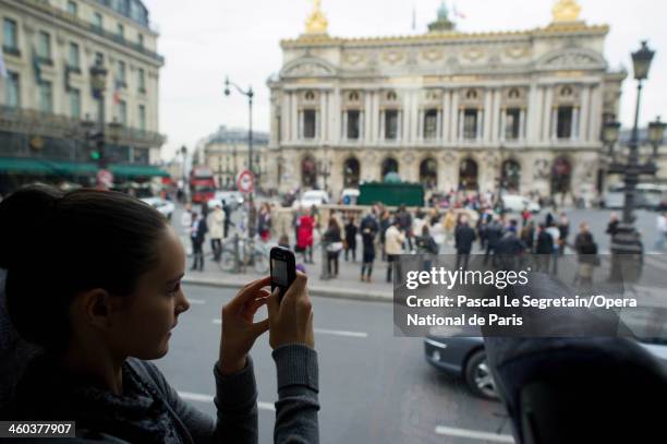 National Opera ballet school pupil takes a picture of the Opera Garnier before a rehersal for the annual "Defile" performance on September 21, 2012...