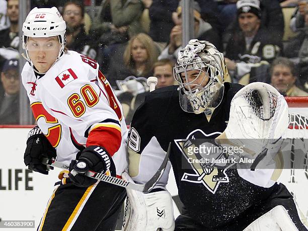 Marc-Andre Fleury of the Pittsburgh Penguins makes a save against Markus Granlund of the Calgary Flames in the second period during the game at...