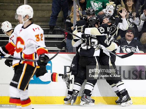 Rob Klinkhammer of the Pittsburgh Penguins celebrates with Steve Downie and Evgeni Malkin after scoring in the third period against the Calgary...