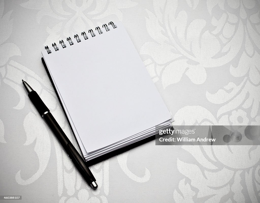 Notebook with pen, blank