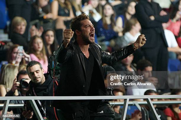 Spanish singer David Bisbal receives an 40 Principales award during the "40 Principales" awards 2013 ceremony at the Barclaycard Center on December...