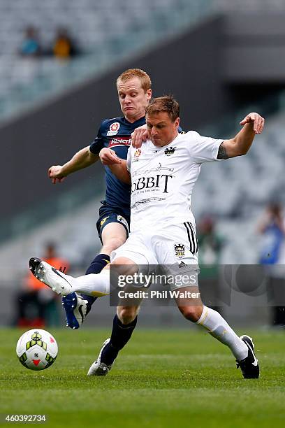 Ben Sigmund of the Phoenix is held by Matthew Simon of the Mariners during the round 11 A-League match between the Wellington Phoenix and the Central...