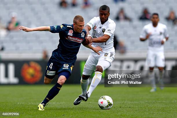 Rolieny Bonevacia of the Phoenix is held back by Jacob Poscoliero of the Mariners during the round 11 A-League match between the Wellington Phoenix...