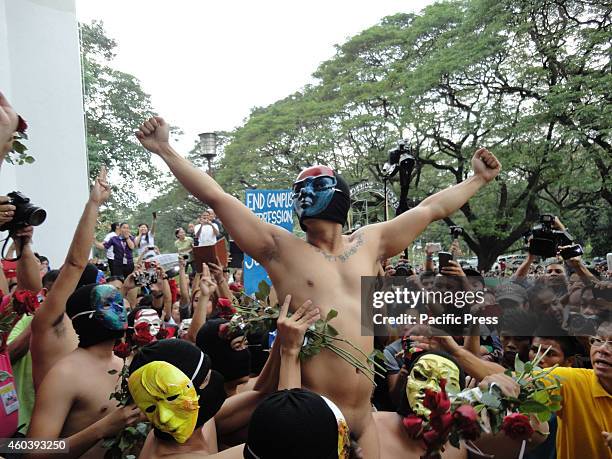 Member from the Filipino fraternity Alpha Phi Omega poses while being hoisted by fellow members of the fraternity in the annual Oblation Run at the...