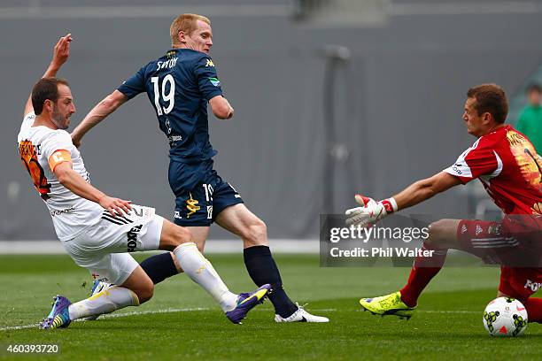 Matthew Simon of the Mariners sends the ball past goalkeeper Glen Moss of the Phoenix to score a goal during the round 11 A-League match between the...