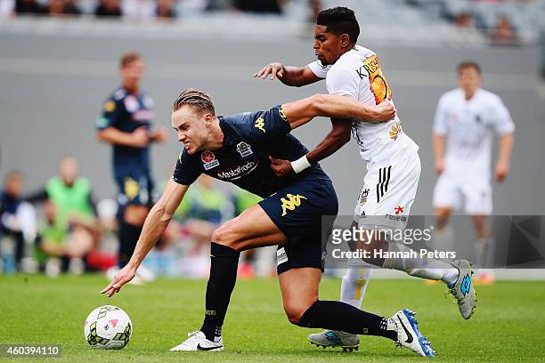 Roy Krishna of the Phoenix defends over the top of Zachary Anderson of the Mariners during the round 11 A-League match between Wellington Phoenix and...