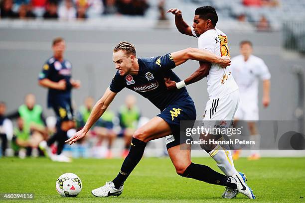 Roy Krishna of the Phoenix defends over the top of Zachary Anderson of the Mariners during the round 11 A-League match between Wellington Phoenix and...