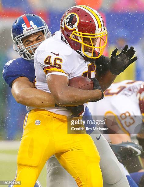 Spencer Paysinger of the New York Giants in action against Alfred Morris of the Washington Redskins on December 29, 2013 at MetLife Stadium in East...
