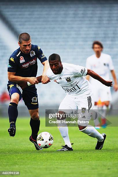 Nick Montgomery of the Mariners competes with Rolieny Bonevacia of the Phoenix for the ball during the round 11 A-League match between Wellington...
