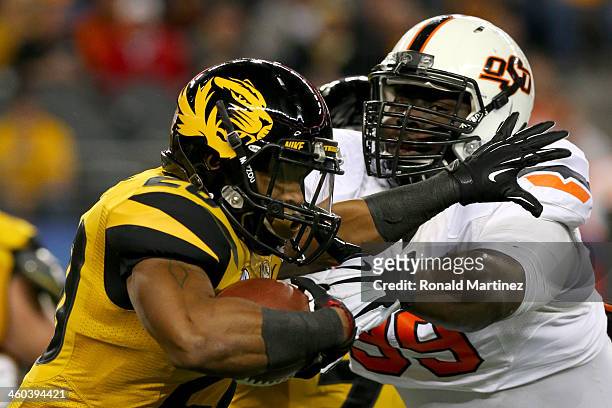 Running back Henry Josey of the Missouri Tigers runs against Calvin Barnett of the Oklahoma State Cowboys in the first half during the AT&T Cotton...
