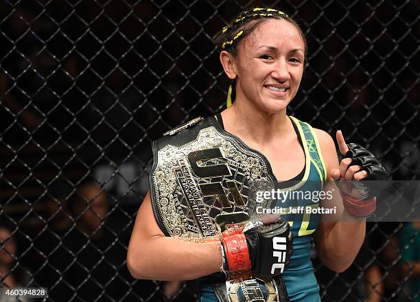 Carla Esparza celebrates her submission victory over Rose Namajunas in the third round and becomes the first UFC women's srawwieght champion during...