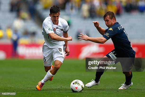 Louis Fenton of the Phoenix is put under pressure from Nick Fitzgerald of the Mariners during the round 11 A-League match between the Wellington...