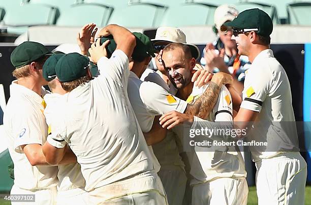 Nathan Lyon of Australia celebrates with his teammates after taking the wicket of Virat Kohli of India during day five of the First Test match...