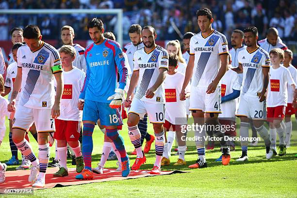 Landon Donovan of the Los Angeles Galaxy and his teammates walk onto the field prior to the 2014 MLS Cup match between the New England Revolution and...