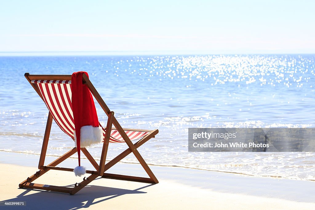 Christmas santa hat on a beach chair. Australia.