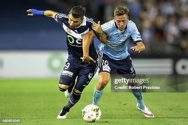 Kosta Barbarouses of Victory and Alexander Gersbach of Sydney contest the ball during the round 11 A-League match between Melbourne Victory and...