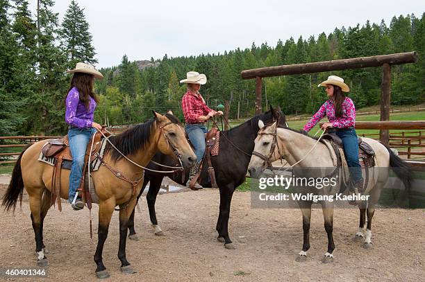 Cowgirls with their horses at Averill's Flathead Lake Lodge, a dude ranch near Kalispell, Montana, United States.