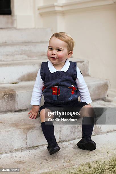 In this handout image of three released on December 13, 2014 by Kensington Palace, Prince George sits for his official Christmas picture in a...