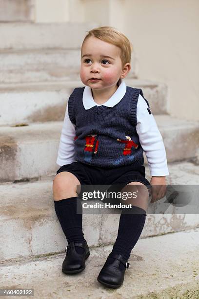 In this handout image of three released on December 13, 2014 by Kensington Palace, Prince George sits for his official Christmas picture in a...