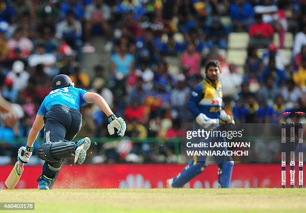 England cricketer Jos Buttler is run out as Sri Lankan wicketkeeper Kumar Sangakkara looks on during the sixth One Day International match between...