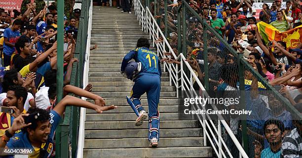 Kumar Sangakkara of Sri Lanka leaves the field after winning the 6th One Day International match between Sri Lanka and England at Pallekele Cricket...