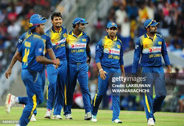 Sri Lankan cricketer Suranga Lakmal celebrates with his teammates after he dismissed England cricketer James Tredwell during the sixth One Day...