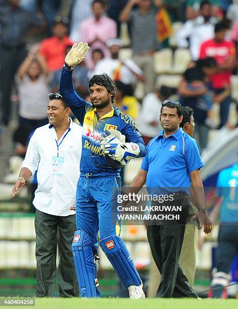 Sri Lankan cricketer Kumar Sangakkara waves to the crowd after his team's victory in the sixth One Day International match between Sri Lanka and...