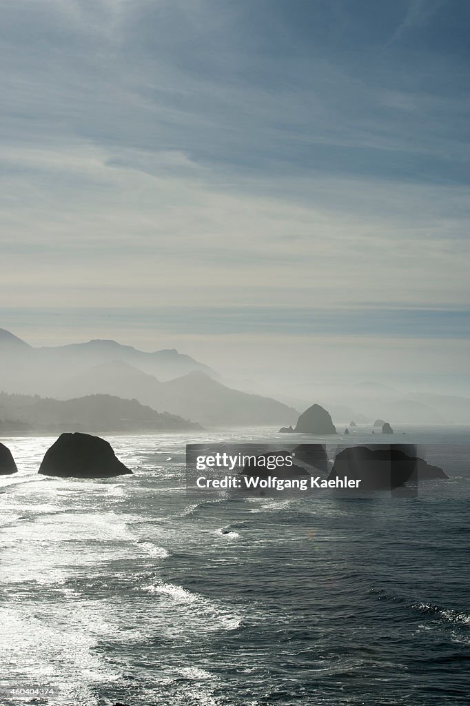 View of backlit Haystack Rock and sea stacks from Ecola...