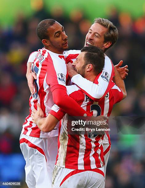 Peter Crouch of Stoke City celebrates with team mates Steven N'Zonzi and Erik Pieters as he scores their first goal during the Barclays Premier...