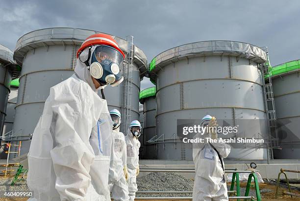 Chairman Shunichi Tanaka inspects storage tanks holding water contaminated with radioactive substances at the Fukushima Daiichi Nuclear Power Plant...