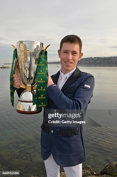 Scott Brash holds the Rolex IJRC Top Ten trophy from riding Hello Sanctos and winning the Rolex IJRC Top 10 Final on Lake Geneva on December 13, 2014...