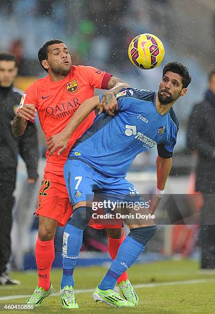 Daniel Alves of FC Barcelona battles for the ball against Angel Lafita of Getafe CF during the La Liga match between Getafe CF and FC Barcelona at...