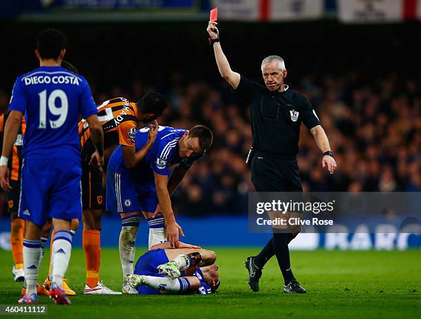 Referee Chris Foy shows a red card to Tom Huddlestone of Hull City after a challenge on Felipe Luis of Chelsea during the Barclays Premier League...