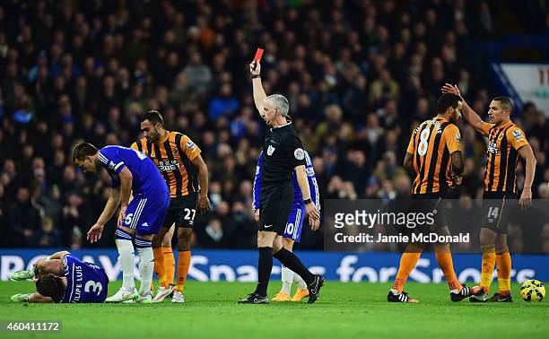 Referee Chris Foy shows a red card to Tom Huddlestone of Hull City after a challenge on Filipe Luis of Chelsea during the Barclays Premier League...