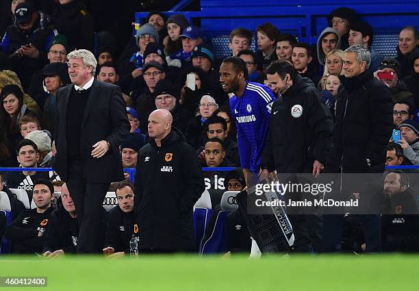 Steve Bruce manager of Hull City, substitute Didier Drogba of Chelsea and Jose Mourinho manager of Chelsea smile during the Barclays Premier League...