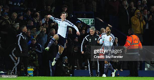 Player Craig Gardner celebrates his goal with manager Alan Irvine and Joleon Lescott during the Barclays Premier League match between West Bromwich...