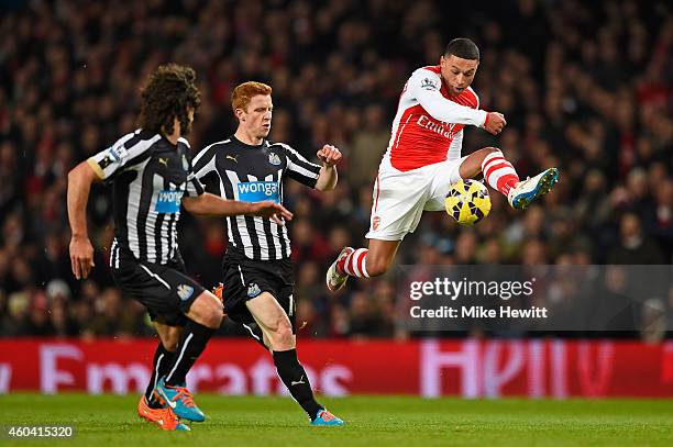 Alex Oxlade-Chamberlain of Arsenal controls the ball under pressure from Jack Colback of Newcastle United during the Barclays Premier League match...