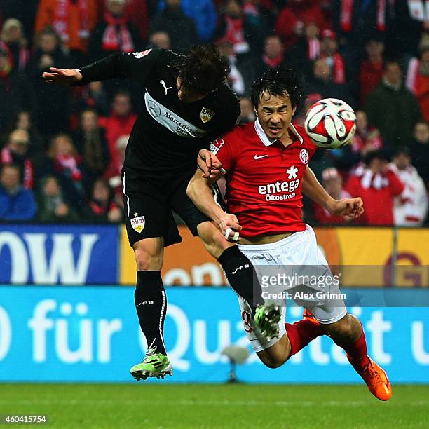 Gotoku Sakai of Stuttgart jumps for a header with Shinji Okazaki of Mainz during the Bundesliga match between 1. FSV Mainz 05 and VfB Stuttgart at...