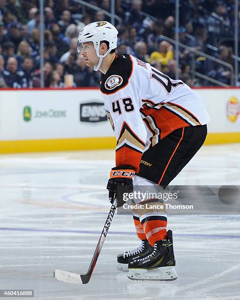 Colby Robak of the Anaheim Ducks keeps an eye on the play during third period action against the Winnipeg Jets on December 7, 2014 at the MTS Centre...