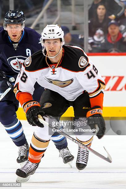 Colby Robak of the Anaheim Ducks follows the play down the ice during first period action against the Winnipeg Jets on December 7, 2014 at the MTS...