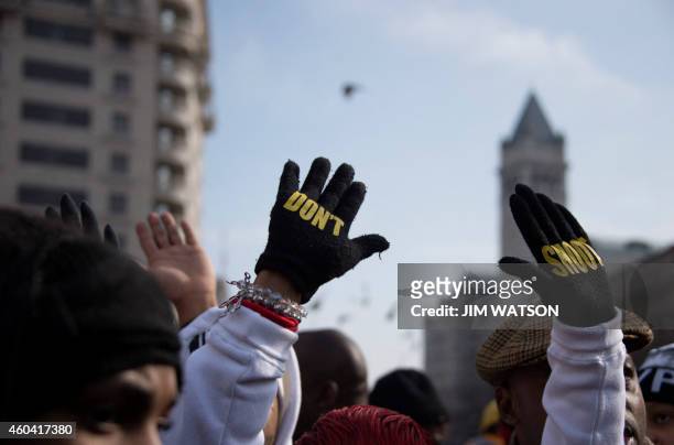 Lesley McSpadden , mother of Ferguson shooting victim Michael Brown, holds up her hands with gloves that say "Don't Shoot" during the "Justice For...